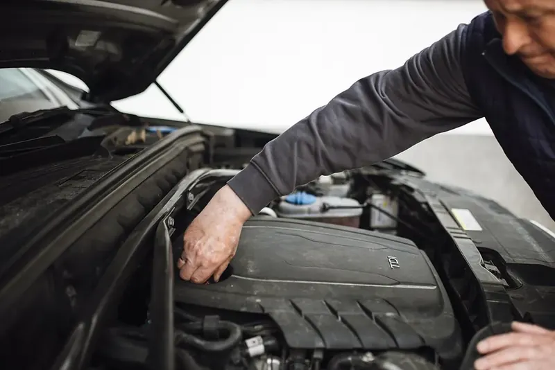 A mechanic checking over an engine bay