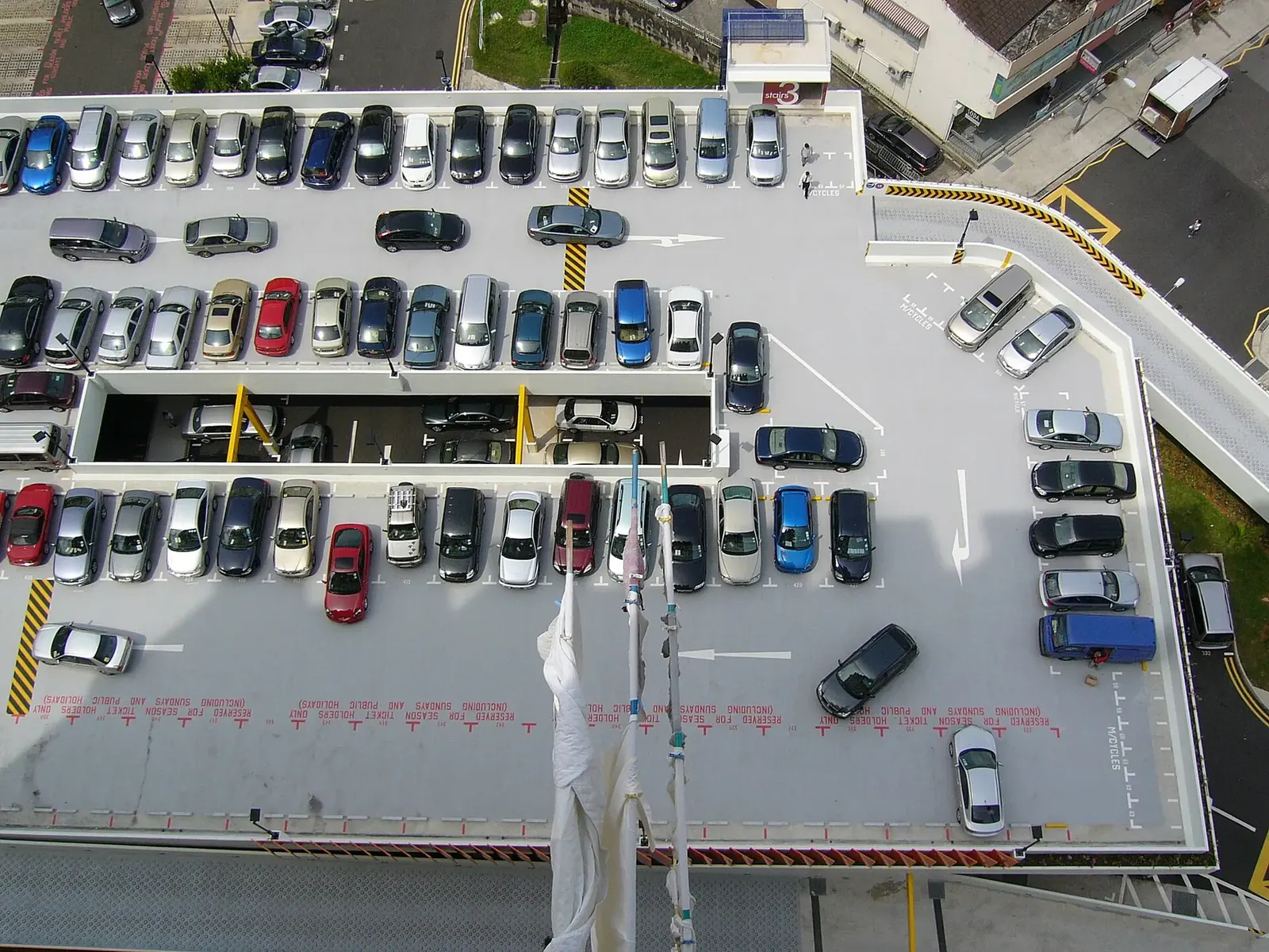 Cars parked in rows on the upper deck of a Singapore carpark